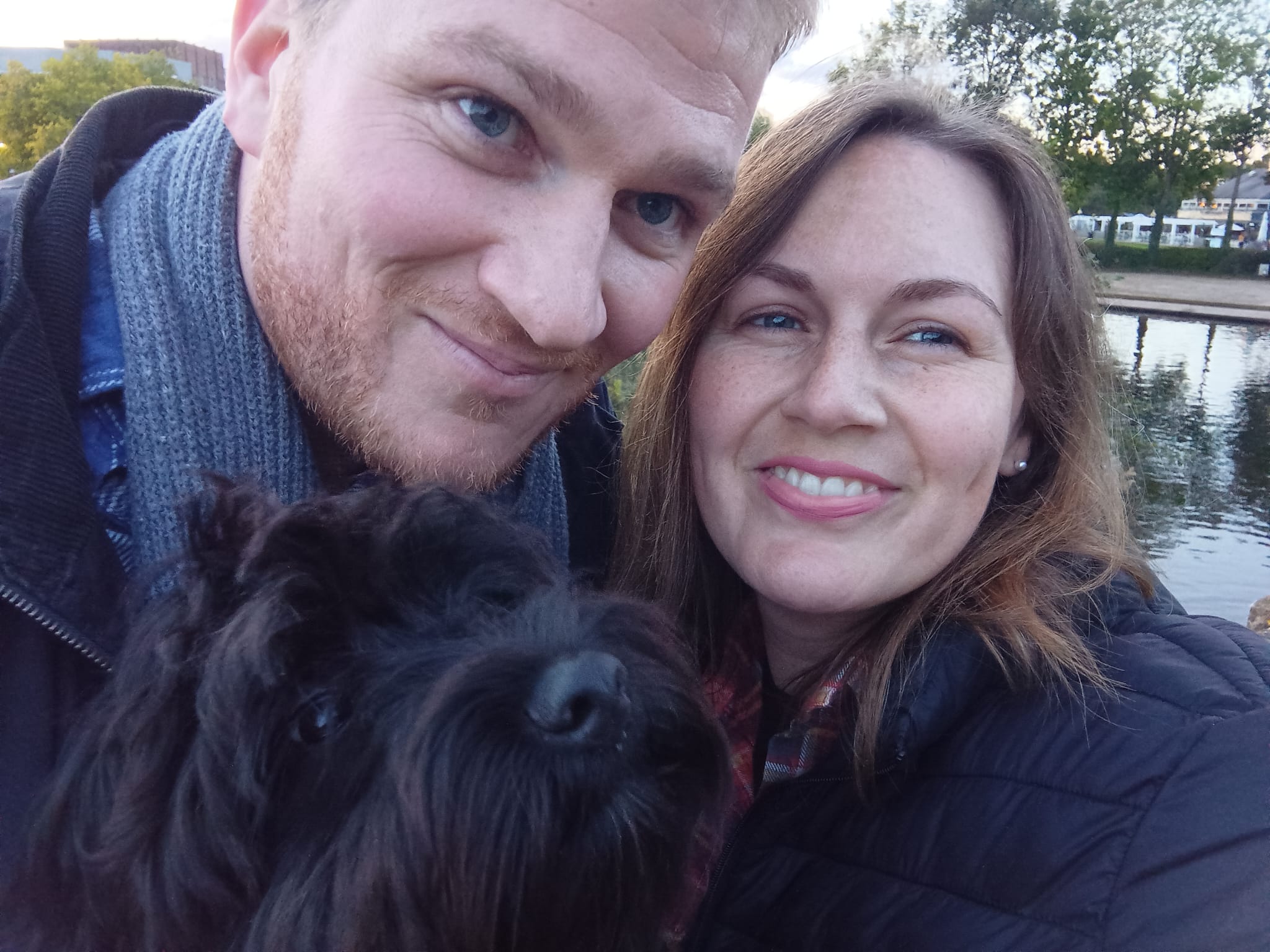 Photograph showing podiatrist Josephine smiling with her husband and dog Wilfie